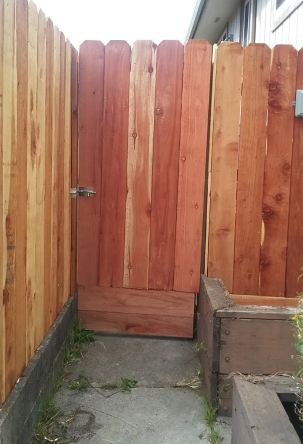 New cedar gate integrated into a fence