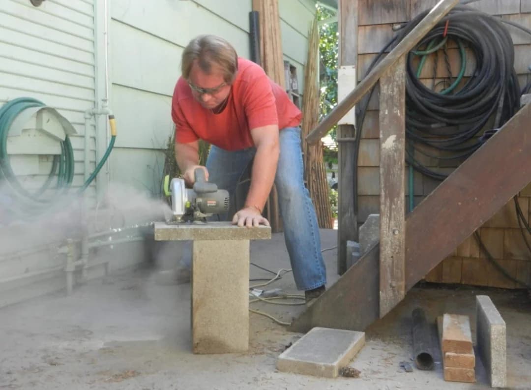 Mark Novak cutting a masonry block during a construction project