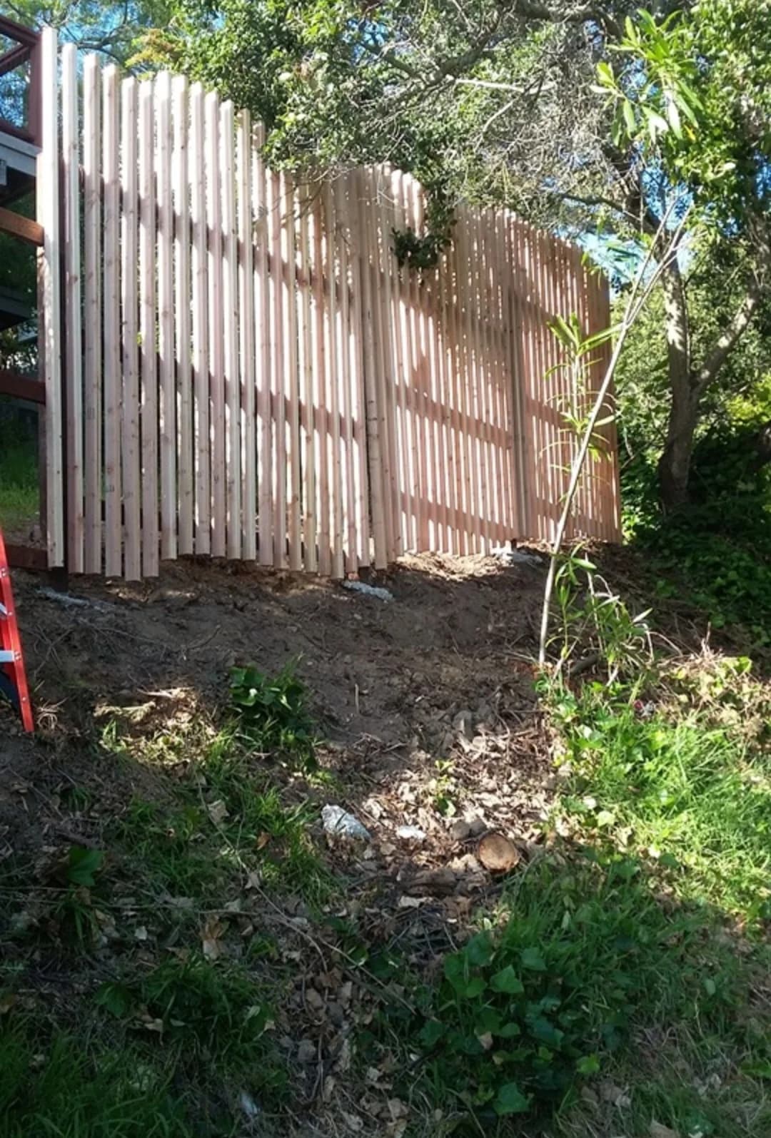 Completed cedar privacy fence following a hillside grade