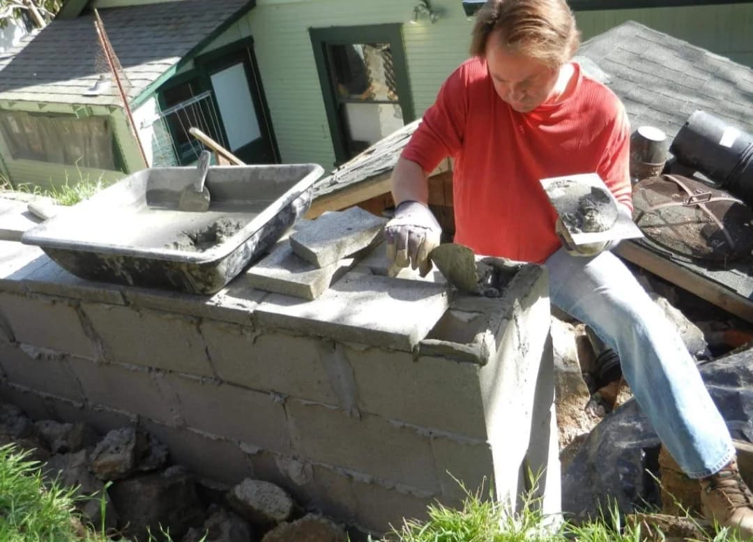 Mark Novak applying mortar while building a masonry wall